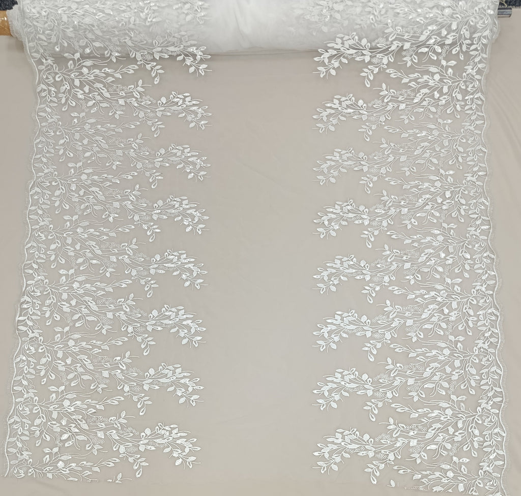 detaliu al broderiei florale cu paiete pe tull alb.